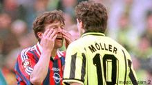 Lothar Matthäus rubs away phanton tears while getting into Andreas Möller's face.