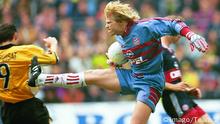 Oliver Kahn kicks at Stephane Chapuisat with the studs showing.