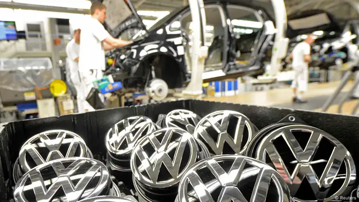 Emblems of VW Golf VII car are pictured in a production line at the plant of German carmaker Volkswagen in Wolfsburg in this February 25, 2013 file photo. Volkswagen said February 27, 2013 it will pay its German workers a 7,200-euro ($9,400) bonus for 2012, a reduction of 4 percent on the previous year's payout despite Europe's biggest car maker having posted a record profit and sales. Picture taken February 25, 2013. REUTERS/Fabian Bimmer/file (GERMANY - Tags: TRANSPORT)
