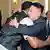 North Korean leader Kim Jong-Un and former NBA basketball player Dennis Rodman (front L) hug in Pyongyang in this undated picture released by North Korea's KCNA news agency on March 1, 2013. KCNA reported that a mixed basketball game of visiting U.S. basketball players and North Korean players was held at Ryugyong Jong Ju Yong Gymnasium on February 28, 2013. REUTERS/KCNA (NORTH KOREA - Tags: POLITICS SPORT BASKETBALL) ATTENTION EDITORS - THIS PICTURE WAS PROVIDED BY A THIRD PARTY. REUTERS IS UNABLE TO INDEPENDENTLY VERIFY THE AUTHENTICITY, CONTENT, LOCATION OR DATE OF THIS IMAGE. THIS PICTURE IS DISTRIBUTED EXACTLY AS RECEIVED BY REUTERS, AS A SERVICE TO CLIENTS. QUALITY FROM SOURCE. NO THIRD PARTY SALES. NOT FOR USE BY REUTERS THIRD PARTY DISTRIBUTORS