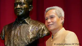 FILE - In this Aug. 31, 2005 file photo, Sombath Somphone of Laos, the winner of Ramon Magsaysay Award for Community Leadership in 2005, poses with the bust of the late Philippine president prior to receiving his award in ceremony at the Cultural Center of the Philippines in Manila. The respected social activist has gone missing in Laos, and a colleague involved in the search for him said that he saw evidence that police had taken him into custody. A statement issued Tuesday, Dec. 18, 2012 on behalf of 61 Thai nongovernmental organizations said Sombath disappeared Saturday afternoon in the Lao capital, Vientiane, where friends last saw him getting into his car to drive home from the development agency he founded. The Ramon Magsaysay Award is one of Asia's top civil honors. (AP Photo/Bullit Marquez, File)