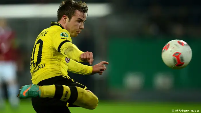 Dortmund's midfielder Mario Goetze scores during the German Cup football match Borussia Dortmund vs Hanover 96 in Dortmund, western Germany, on December 19, 2012. Dortmund won the match 5-1. AFP PHOTO / PATRIK STOLLARZ RESTRICTIONS / EMBARGO - DFB RULES PROHIBIT THE USE IN MMS SERVICES VIA HANDHELD DEVICES UNTIL TWO HOURS AFTER A MATCH. IMAGE SEQUENCES TO SIMULATE VIDEO IS NOT ALLOWED AT ANY TIME. FOR FURTHER QUERIES PLEASE CONTACT THE DFB DIRECTLY AT +49 69 67880. (Photo credit should read PATRIK STOLLARZ/AFP/Getty Images)