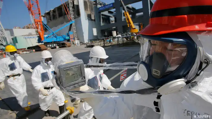 A radiation monitor indicates 114.00 microsieverts per hour near the No.4 reactor (background C) and it's foundation construction (background R) for the storage of melted fuel rods at Tokyo Electric Power Co. (TEPCO)'s tsunami-crippled Fukushima Daiichi nuclear power plant in Fukushima prefecture, March 6, 2013, ahead of the second-year of anniversary of the the March 11, 2011 tsunami and earthquake. Members of the media were allowed into the plant on Wednesday ahead of the second-year anniversary of the tsunami and earthquake, which triggered the world's worst nuclear crisis since Chernobyl. REUTERS/Issei Kato (JAPAN - Tags: DISASTER ANNIVERSARY ENERGY)