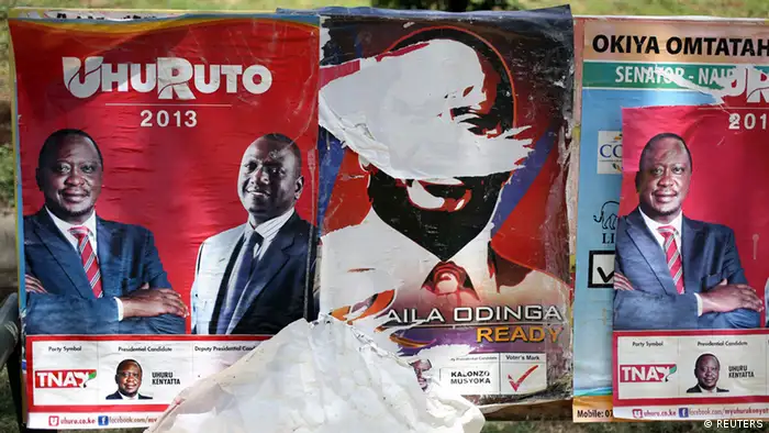 Posters of presidential candidates Uhuru Kenyatta and Prime Minister Raila Odinga (C) are seen in Nairobi March 8, 2013. Kenya's presidential race tightened on Friday with frontrunner Kenyatta gaining just under half of the ballots counted four days after the vote, raising the prospect of a tense run-off against his main rival Odinga. REUTERS/Goran Tomasevic (KENYA - Tags: POLITICS ELECTIONS)