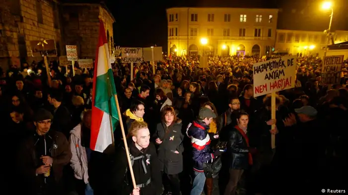 Hungarians attend a demonstration after parliament voted for government-backed constitutional amendments, in Budapest March 11, 2013. Hungary defied the European Union on Monday and adopted legislation that critics say will limit the powers of the constitutional court, one of the few institutions that has stood up to Viktor Orban, the combative prime minister. Parliament, dominated by Orban's Fidesz party, voted for a set of government-backed constitutional amendments, despite warnings from the European Union, the U.S. government and human rights groups that the changes could undermine Hungary's democracy. REUTERS/Laszlo Balogh (HUNGARY - Tags: POLITICS CIVIL UNREST TPX IMAGES OF THE DAY)