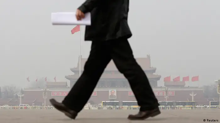 A man walks in front of Tiananmen Gate in the dust storm and haze in Beijing March 8, 2013. The 12th National People's Congress goes on till March 17th. China's new rulers will focus on consumer-led growth to narrow the gap between rich and poor while taking steps to curb pollution and graft, the government said on Tuesday, tackling the main triggers for social unrest in the giant nation. REUTERS/Jason Lee (CHINA - Tags: POLITICS ENVIRONMENT BUSINESS)