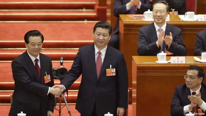 China's newly-elected President Xi Jinping shakes hands with former President Hu Jintao as other delegates clap during the fourth plenary meeting of the National People's Congress (NPC) at the Great Hall of the People in Beijing, March 14, 2013. China's parliament formally elected heir-in-waiting Xi as the country's new president on Thursday, succeeding Hu Jintao, putting the final seal of approval on a generational transition of power. REUTERS/Jason Lee (CHINA - Tags: POLITICS TPX IMAGES OF THE DAY)/li