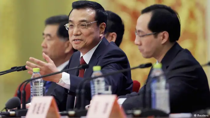 China's newly elected Premier Li Keqiang (2nd R) answers a question during the annual news conference following the closing session of the National People's Congress (NPC), at the Great Hall of the People in Beijing, March 17, 2013. REUTERS/Jason Lee (CHINA - Tags: POLITICS)