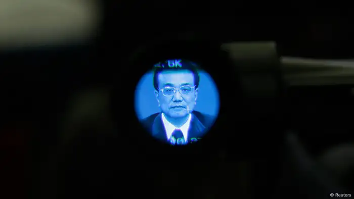 China's newly elected Premier Li Keqiang is seen through a video camera during a news conference after the closing session of the National People's Congress (NPC) at the Great Hall of the People in Beijing, March 17, 2013. REUTERS/Jason Lee (CHINA - Tags: POLITICS)