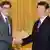U.S. Treasury Secretary Jacob Lew (L) shakes hands with China's President Xi Jinping during their meeting at the Great Hall of the People in Beijing March 19, 2013. REUTERS/Andy Wong/Pool (CHINA - Tags: POLITICS BUSINESS)