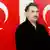 Kurdish rebel leader Abdullah Ocalan poses in front of Turkish flags after he arrived at the prison island of Imrali, in the Marmara Sea near in this February 18, 1999 file photograph. Jailed militant leader Ocalan is set to call on his fighters to halt hostilities with Turkey on March 21, 2013 in a peace process which marks the best hope yet of ending a conflict that has killed 40,000 and handicapped the country for decades. REUTERS/Handout/Files (TURKEY - Tags: POLITICS CRIME LAW) ATTENTION EDITORS - THIS IMAGE WAS PROVIDED BY A THIRD PARTY. FOR EDITORIAL USE ONLY. NOT FOR SALE FOR MARKETING OR ADVERTISING