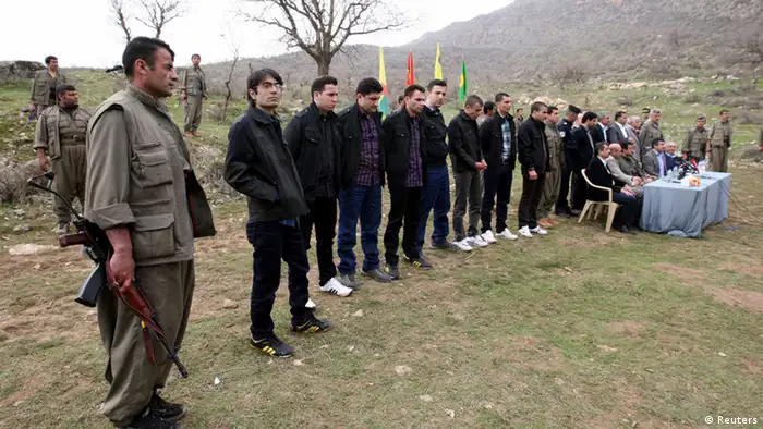 Turkish soldiers and officials, wearing black coats, who had been held captive by PKK militants are seen before they are released in the northern Iraqi city of Dohuk, in this March 13, 2013 file photo. Jailed Kurdish militant leader Abdullah Ocalan is set to call on his fighters to halt hostilities with Turkey on March 21, 2013 in a peace process which marks the best hope yet of ending a conflict that has killed 40,000 and handicapped the country for decades. REUTERS/Azad Lashkari/Files (IRAQ - Tags: CIVIL UNREST POLITICS)
