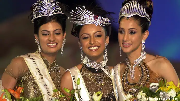 Tanushree Datta,center, winner of Miss India Universe, smiles along with Lakshmi Pandit, right, winner of Miss India World and Sayali Bhagat, left, winner of Miss India Earth after the finals of Femina Miss India Pageant 2004 in Bombay, India, Saturday, March 27, 2004. Datta will represent India for Pageant Miss Universe contest. (AP Photo/Rajesh Nirgude)