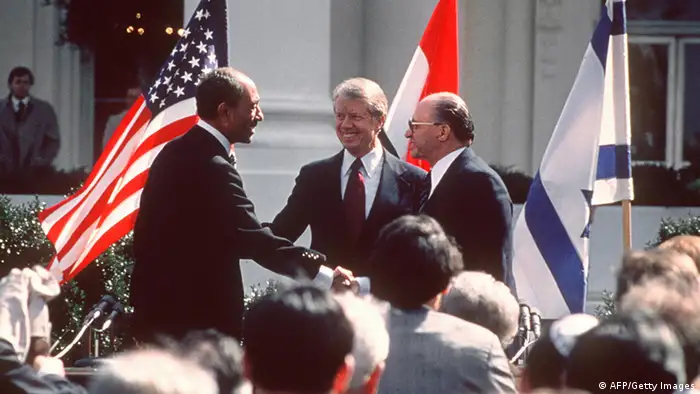 US President Jimmy Carter congratulates Egyptian President Anwar al-Sadat and Israeli Premier Menachem Begin