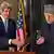 Secretary of State John Kerry reaches to shake hands with Afghan President Hamid Karzai during their joint news conference at the Presidential Palace in Kabul, Monday, March 25, 2013. (AP Photo/Jason Reed)