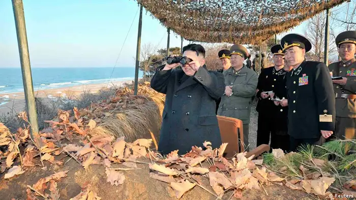 North Korean leader Kim Jong-Un (L) watches soldiers of the Korean People's Army (KPA) taking part in the landing and anti-landing drills of KPA Large Combined Units 324 and 287 and KPA Navy Combined Unit 597, in the eastern sector of the front and the east coastal area on March 25, 2013, in this picture released by the North's KCNA news agency in Pyongyang March 26, 2013. REUTERS/KCNA (NORTH KOREA - Tags: POLITICS MILITARY) ATTENTION EDITORS - THIS PICTURE WAS PROVIDED BY A THIRD PARTY. REUTERS IS UNABLE TO INDEPENDENTLY VERIFY THE AUTHENTICITY, CONTENT, LOCATION OR DATE OF THIS IMAGE. THIS PICTURE IS DISTRIBUTED EXACTLY AS RECEIVED BY REUTERS, AS A SERVICE TO CLIENTS. QUALITY FROM SOURCE. NO THIRD PARTY SALES. NOT FOR USE BY REUTERS THIRD PARTY DISTRIBUTORS