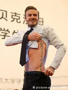 English soccer superstar David Beckham shows his tattoos of Chinese characters during an exchange meeting at Peking University in Beijing, China, 24 March 2013. David Beckham arrived in Beijing on Wednesday (20 March 2013) morning to start his China tour as the image ambassador of the Chinese Super League. Tao Zi/dpa