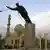 FILE - A U.S. Marine watches a statue of Saddam Hussein being toppled in Firdaus Square in downtown Baghdad on April 9, 2003 file photo. (AP Photo/Jerome Delay, File)