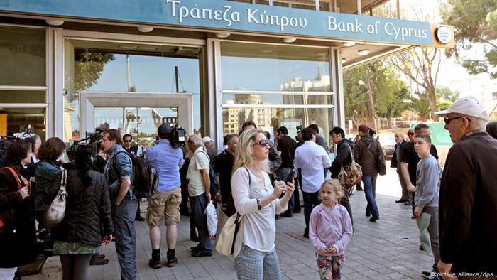Customers and media representatives waiting outside a branch of the Bank of Cyprus, in Nicosia, Cyprus, in the morning of March 28, 2013 morning. All of the country's 26 banks were open from 12 pm until 6 pm with a withdrawal limit set at 300 euros ($383) per person. Cyprus was braced for the reopening of its banks after nearly two weeks, after the government imposed tough capital controls for at least the next seven days. Police were going from bank to bank in central Nicosia to prevent problems, while dozens of people had started to queue in front of the banks' doors. Copyright: EPA/KATIA CHRISTODOULOU