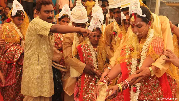 Couples during a mass marriage ceremony in Calcutta, India on 17 March 2013 
