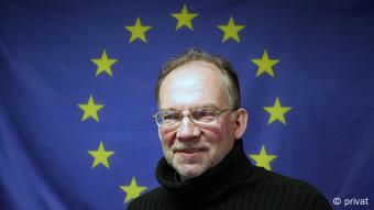 Руководитель Белорусской аналитической мастерской, профессор Андрей Вардомацкий на фоне флага Евросоюза