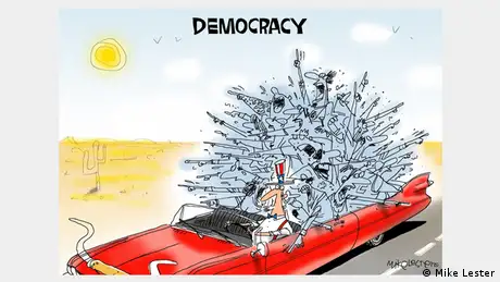 Karikatur in Farbe von Mike Lester; Uncle Sam fährt im roten Cabrio durch die Wüste und eine Menschenmasse gibt unterschiedlichste Richtungsweisungen an 