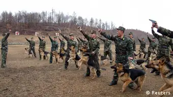 North Korean soldiers with military dogs take part in drills in an unknown location in this picture taken on April 6, 2013 and released by North Korea's official KCNA news agency in Pyongyang on April 7, 2013. REUTERS/KCNA (NORTH KOREA: - Tags: POLITICS MILITARY) ATTENTION EDITORS - THIS PICTURE WAS PROVIDED BY A THIRD PARTY. REUTERS IS UNABLE TO INDEPENDENTLY VERIFY THE AUTHENTICITY, CONTENT, LOCATION OR DATE OF THIS IMAGE. IT IS DISTRIBUTED, EXACTLY AS RECEIVED BY REUTERS, AS A SERVICE TO CLIENTS. FOR EDITORIAL USE ONLY. NOT FOR SALE FOR MARKETING OR ADVERTISING CAMPAIGNS. NO THIRD PARTY SALES. NOT FOR USE BY REUTERS THIRD PARTY DISTRIBUTORS
