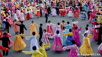 North Koreans dance on a street in Pyongyang as they celebrate the 20th anniversary of late leader Kim Jong-il's election as chairman of North Korea's National Defence Commission, in this picture taken and released by the North's official KCNA news agency on April 9, 2013. REUTERS/KCNA (NORTH KOREA - Tags: ANNIVERSARY MILITARY POLITICS) ATTENTION EDITORS - THIS PICTURE WAS PROVIDED BY A THIRD PARTY. REUTERS IS UNABLE TO INDEPENDENTLY VERIFY THE AUTHENTICITY, CONTENT, LOCATION OR DATE OF THIS IMAGE. THIS PICTURE IS DISTRIBUTED EXACTLY AS RECEIVED BY REUTERS, AS A SERVICE TO CLIENTS. NO THIRD PARTY SALES. NOT FOR USE BY REUTERS THIRD PARTY DISTRIBUTORS