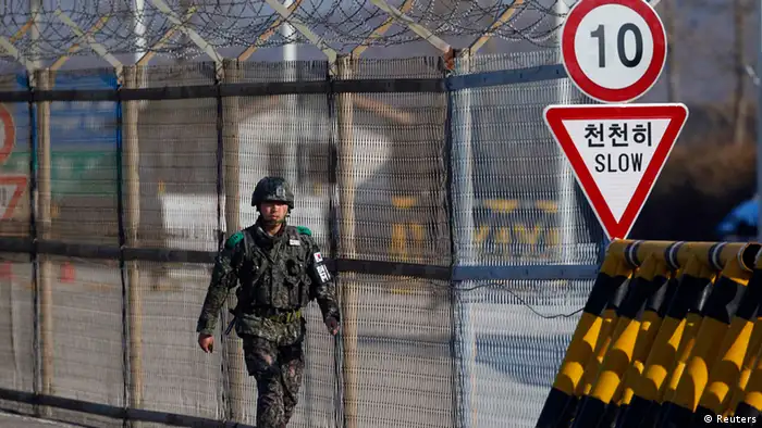 A South Korean soldier patrols along a barbed-wire fence at a checkpoint on the Grand Unification Bridge, which leads to the demilitarized zone separating North Korea from South Korea, in Paju, north of Seoul April 10, 2013. South Korea has raised its surveillance of North Korea after the reclusive state moved one or more long-range missiles in readiness for a possible launch, Yonhap news agency reported on Wednesday. REUTERS/Kim Hong-Ji (SOUTH KOREA - Tags: POLITICS MILITARY)