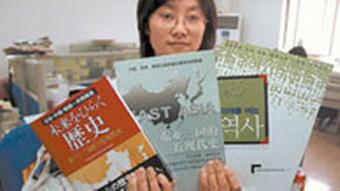 A Chinese women demonstrated a history textbook titled Modern history of East Asia