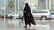 A Saudi woman wearing a black headscarf and black robes arives at a shopping mall, with parked cars in the background. Copyright: FAYEZ NURELDINE / AP A Saudi woman wearing a black headscarf and black robes arives at a shopping mall, with parked cars in the background. Copyright: FAYEZ NURELDINE / AP
