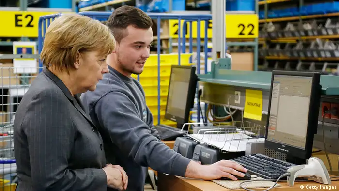 LEINFELDEN-ECHTERDINGEN, GERMANY - APRIL 09: German Chancellor Angela Merkel (L) talks with trainee Rilind Brkolli (R), who is an immigrant from Kosovo, at the Mader GmbH company on April 9, 2013 in Leinfelden-Echterdingen, Germany. The Mader company specializes in job training and integration programs for immigrants. Merkel was visiting the facility as part of her national tour of companies and institutions working constructively with Germany's demographic change. (Photo by Thomas Niedermueller/Getty Images)