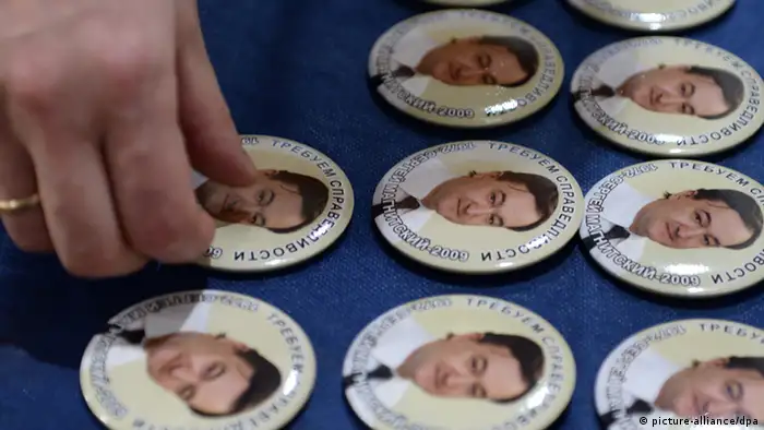 ITAR-TASS: MOSCOW, RUSSIA. APRIL 8, 2013. Pins bearing portraits of Sergei Magnitsky, an accountant and auditor at the British investment company Hermitage Capital Management. Sergei Magnitsky died in custody in November 2009 at the age of 37. The Moscow Sakharov Cen¬ter marks the 41st birth¬day of the late lawyer. (Photo ITAR-TASS/ Stanislav Krasilnikov)
