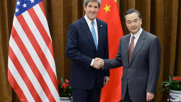 U.S. Secretary of State John Kerry (L) shakes hands with China's Foreign minister Wang Yi before a meeting at the Chinese Foreign Ministry in Beijing April 13, 2013. REUTERS/Yoshuke Mizuno/Pool (CHINA - Tags: POLITICS)