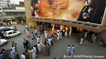 Lahore, PAKISTAN: Pakistani cinema goers queue for tickets for the Indian classic movie Mughal-e-Azam outside the Gulistan Cinema in Lahore, 23 April 2006. The forbidden love of Pakistanis for Indian movies was allowed into the open on 23 April with the public screening of a 1960 classic beloved on both sides of the border. AFP PHOTO/Arif ALI (Photo credit should read Arif Ali/AFP/Getty Images)