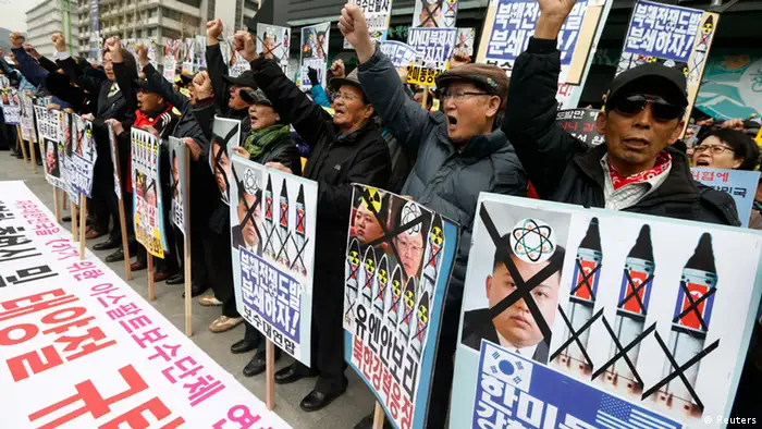 Anti-North Korean protesters from conservative, right-wing and pro-U.S. civic groups, chant slogans during a protest in central Seoul April 15, 2013. North Korea celebrated the 101st anniversary of its founder's birth with flowers on Monday, although there was no sign of tension easing as South Korea warned that the North's survival could be in question without change and development. REUTERS/Lee Jae-Won (SOUTH KOREA - Tags: ANNIVERSARY CIVIL UNREST MILITARY POLITICS)