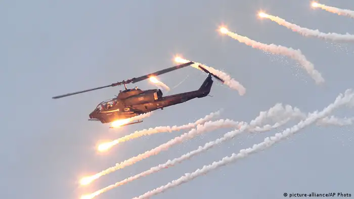 An AH-1W Attack Helicopter launches flares during Han Kuang military exercises in Penghu county, Taiwan, April 17, 2013. Taiwan has held its first large-scale live-fire military exercise in five years, as President Ma Ying-jeou called on soldiers to maintain their sense of crisis as China builds up its military. (AP Photo/Chiang Ying-ying)