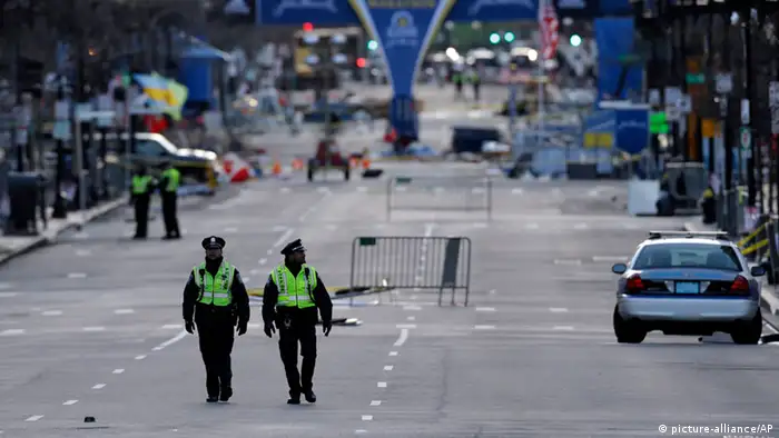 Police officers walk on Boylston Street near the finish line of Monday's Boston Marathon explosions, which killed at least three and injured more than 140, Thursday, April 18, 2013, in Boston. (AP Photo/Matt Rourke)