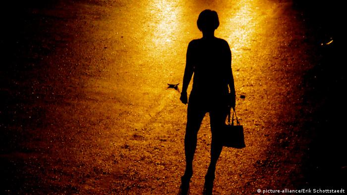 Unidentified woman on the street engages in prostitution