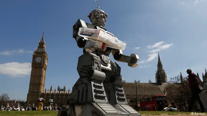 A robot is pictured in front of the Houses of Parliament and Westminster Abbey as part of the Campaign to Stop Killer Robots in London April 23, 2013. Robots with the ability to attack targets without any human intervention must be banned before they are even developed for use in a battlefield, campaigners urged on Tuesday. REUTERS/Luke MacGregor (BRITAIN - Tags: SCIENCE TECHNOLOGY MILITARY CONFLICT POLITICS CIVIL UNREST)