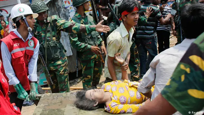 Rescue workers carry a garment worker on a stretcher after pulling her from the rubble of the collapsed Rana Plaza in Savar, 30 km (19 miles) outside Dhaka April 24, 2013. The eight-storey block housing factories and a shopping centre collapsed on the outskirts of the Bangladeshi capital on Wednesday, killing more than 70 people and injuring hundreds, a government official said. REUTERS/Andrew Biraj (BANGLADESH - Tags: DISASTER BUSINESS)