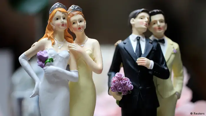 Same-sex couple plastic figurines are displayed during a gay wedding fair (salon du mariage gay) in Paris April 27, 2013, four days after the French parliament approved a law allowing same-sex couples to marry and adopt children. REUTERS/Gonzalo Fuentes (FRANCE - Tags: POLITICS SOCIETY)