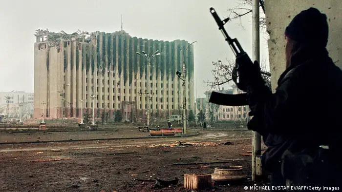 Picture taken on January 10, 1995 shows a Chechen fighter taking cover from sniper fire in a building across the square from the presidential palace destroyed by Russian artillery bombardments. Russia on April 16, 2009 ended an anti-terror operation in Chechnya that has been in place for a decade, amid growing stability in the territory torn by two wars since the collapse of Communism. AFP PHOTO / MICHAEL EVSTAFIEV (Photo credit should read MICHAEL EVSTAFIEV/AFP/Getty Images)