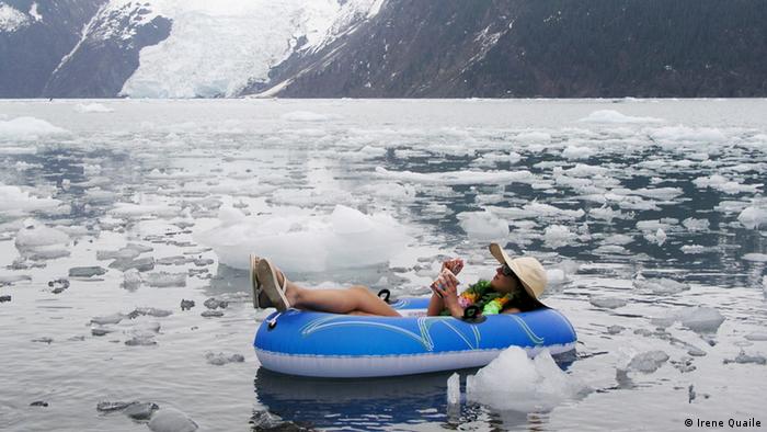 An activist sunbathes in a rubber dinghee in the Arctic