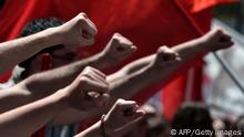 Demonstrators raise their fists during a demonstration on May 1, 2013. A strike stopped ferry services to the Greek islands and disrupted public transport in the capital Athens ahead of May Day protests Wednesday against Greece's prolonged economic austerity policies. AFP PHOTO / ARIS MESSINIS (Photo credit should read ARIS MESSINIS/AFP/Getty Images)