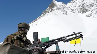 An Indian army solider guards the Srinagar-Leh highway in Zojila Pass about 108 kms, 67 miles, east of Srinagar on April 6, 2013. The 443 km (275 mile) long highway was opened for the season by Indian Army authorities after the remaining snow at Zojila Pass, some 3,530 metres (11,581 feet) above sea level, had been cleared. The pass connects Kashmir with the Buddhist-dominated Ladakh region, a famous tourist destination known for its monasteries, landscapes and mountains. AFP PHOTO/ Rouf BHAT (Photo credit should read ROUF BHAT/AFP/Getty Images)