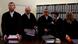 Chief Judge Manfred Goetzl (2L) stands in the court before the start of the trial of Beate Zschaepe, a member of the neo-Nazi group National Socialist Underground (NSU), in Munich May 6, 2013. The surviving member of NSU blamed for a series of racist murders that scandalised Germany and shamed its authorities goes on trial on Monday in one of the most anticipated court cases in recent German history. The trial in Munich will focus on 38-year-old Zschaepe, who is charged with complicity in the murder of eight Turks, a Greek and a policewoman between 2000-2007, as well as two bombings in immigrant areas of Cologne, and 15 bank robberies. REUTERS/Michael Dalder (GERMANY - Tags: POLITICS CRIME LAW) Chief Judge Manfred Goetzl (2L) stands in the court before the start of the trial of Beate Zschaepe, a member of the neo-Nazi group National Socialist Underground (NSU), in Munich May 6, 2013. The surviving member of NSU blamed for a series of racist murders that scandalised Germany and shamed its authorities goes on trial on Monday in one of the most anticipated court cases in recent German history. The trial in Munich will focus on 38-year-old Zschaepe, who is charged with complicity in the murder of eight Turks, a Greek and a policewoman between 2000-2007, as well as two bombings in immigrant areas of Cologne, and 15 bank robberies. REUTERS/Michael Dalder (GERMANY - Tags: POLITICS CRIME LAW)