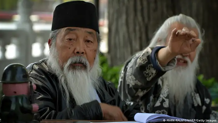Two elderly men wait for customers at their bicycle rental business at Houhai Lake in Beijing on April 29, 2013. China is expected to respond strongly to sustain the economic recovery by increasing efforts to boost domestic investment and consumption in the coming months. China's 2012 growth of 7.8 percent was its slowest in 13 years owing to weakness at home and in overseas markets. AFP PHOTO/Mark RALSTON (Photo credit should read MARK RALSTON/AFP/Getty Images)