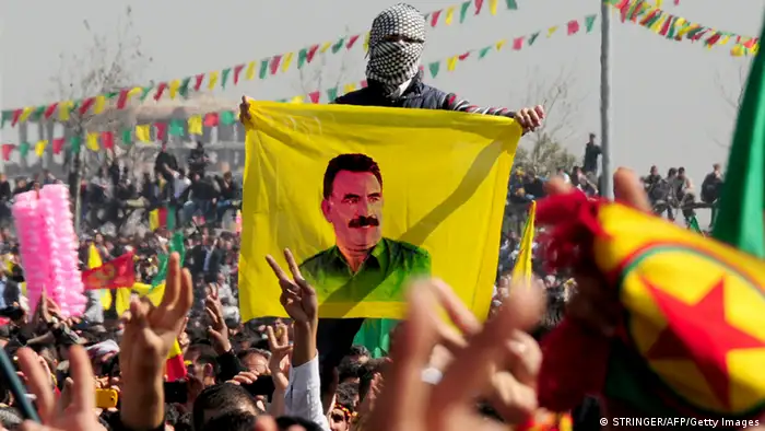 A Kurd celebrates on March 21, 2013 Nowruz, the Persian New Year festival, with a flag bearing a portrait of jailed Kurdish rebel chief Abdullah Ocalan in the southern Turkish city of Diyarbakir. The festival is celebrated in Turkey, Central Asian republics, Iraq, Iran, Azerbaijan as well as war-torn Afghanistan and coincides with the astronomical vernal equinox. Ocalan called on March 21 for a ceasefire, telling militants to lay down their arms and withdraw from Turkish soil, raising hopes for an end to a three-decade conflict with Turkey that has cost tens of thousands of lives. Turkish Prime Minister Recep Tayyip Erdogan responded cautiously to the much-anticipated announcement by saying Turkey would end military operations against Ocalan's outlawed Kurdistan Workers' Party (PKK) if militants halt their attacks. AFP PHOTO / STRINGER (Photo credit should read STRINGER/AFP/Getty Images)