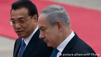 Chinese Premier Li Keqiang, left, chats with Israeli Prime Minister Benjamin Netanyahu during a welcome ceremony outside the Great Hall of the People in Beijing Wednesday, May 8, 2013. (AP Photo/Alexander F. Yuan)